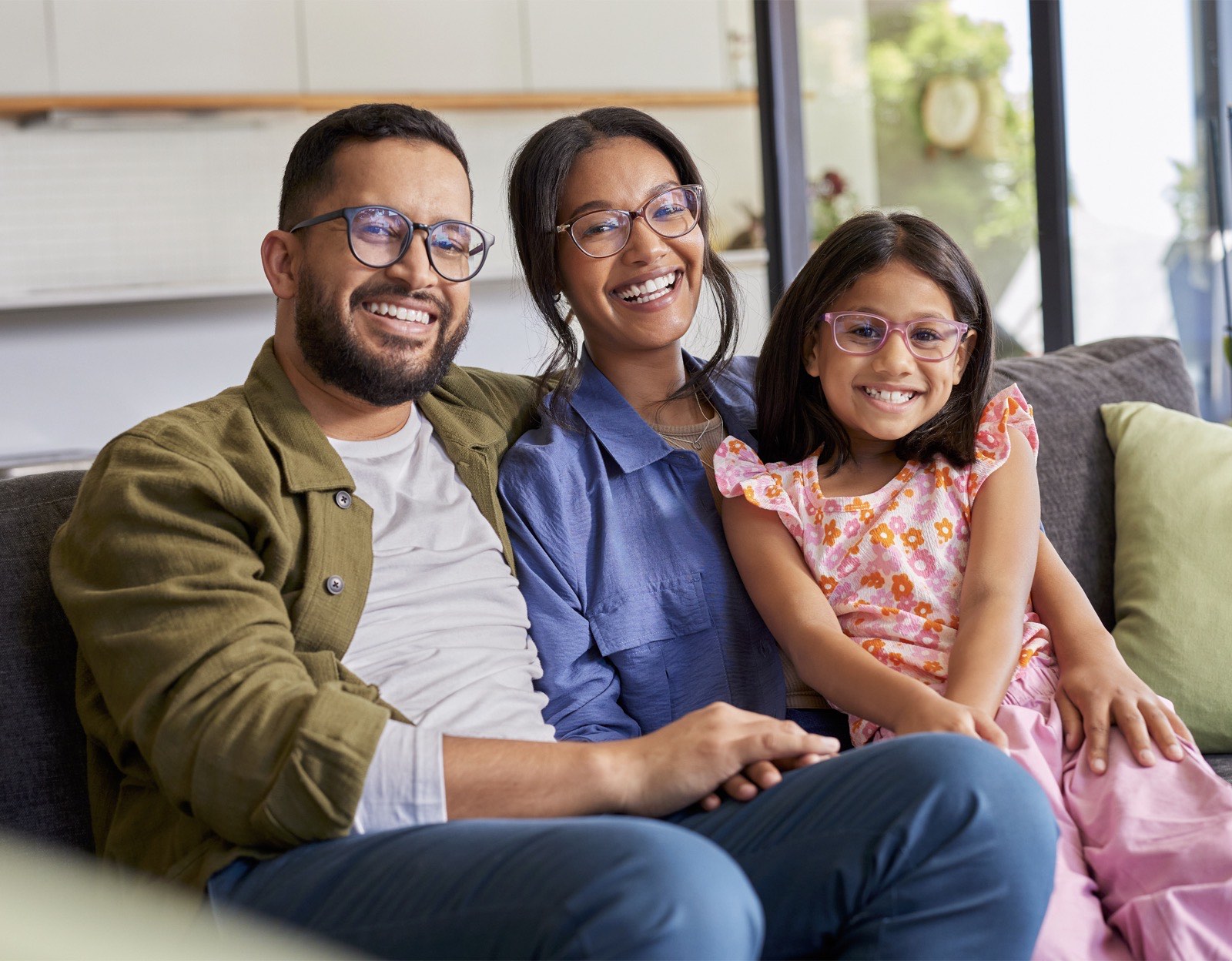 Family wearing glasses together on the couch